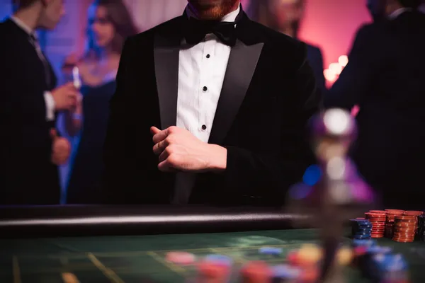 A young woman relaxing with her phone while dynamic casino elements float around her, illustrating the smooth mobile experience offered by the 333OJ app.