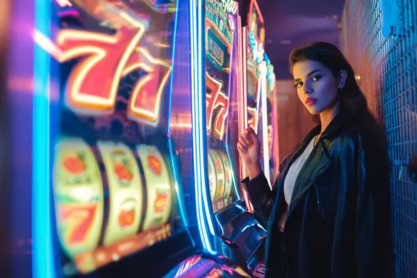 A glamorous woman holding casino chips in a neon-lit environment, representing the premium online casino atmosphere of 333OJ.